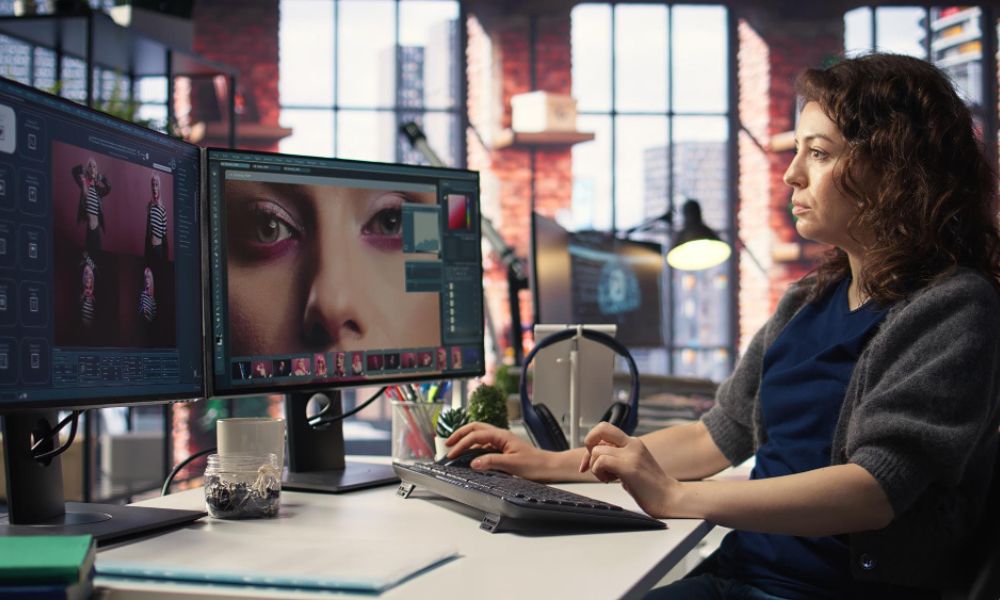 female designer photo editing on her workspace